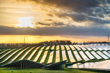 UK Solar Park at sunset,vibrant golden sunlight reflecting from panels,Hampshire,England,United Kingdom.