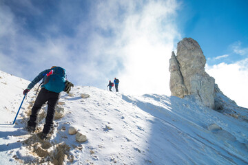 Mountaineer with backpack joining his group in the snowy mountains of Iztaccihuatl - Popocatepetl National Park in Mexico