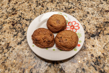 A chocolate chip or chocolate chip cookie is a cookie of American origin with chocolate chips as its distinctive ingredient. The traditional recipe combines a dough based on butter and brown sugar