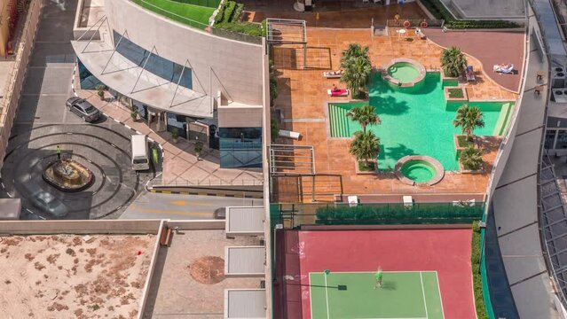 Luxury outdoor swimming pool and relaxing zone around aerial timelapse