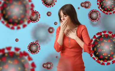 Ill coughing young woman on blue background. Weak immunity concept