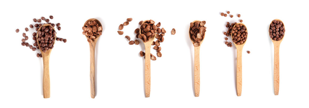 Set of spoons with tasty chocolate corn flakes on white background