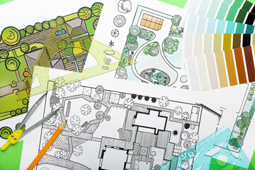 Landscape designer's plans with stationery and color samples on green background - obrazy, fototapety, plakaty