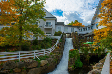 Mill Falls Waterfall in fall at Mill Falls Marketplace in historic town center of Meredith, New...