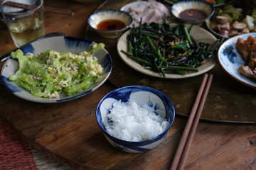 Close view of traditional vietnamese meal chicken vegetable pork and rice decorated in wooden background 