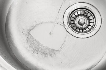 Water pouring into sink, closeup