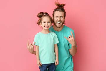 Fototapeta Funny man and her little daughter on pink background. April fools' day celebration obraz