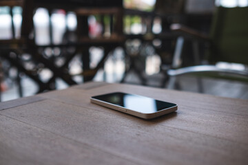 A single mobile phone on wooden table