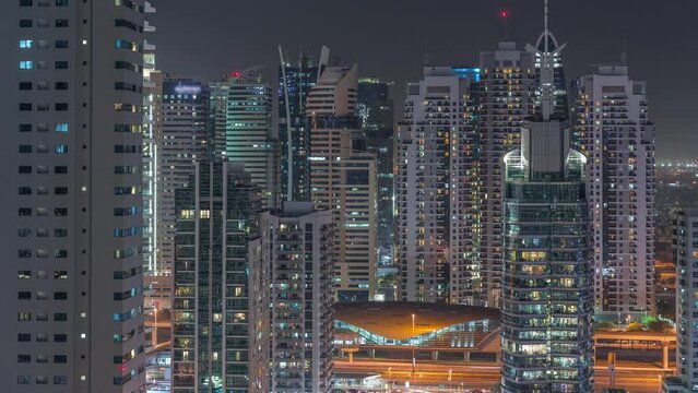 Dubai Marina Skyline with JLT district skyscrapers on a background aerial night timelapse.