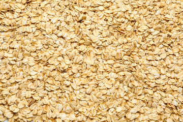 Fresh raw oatmeal flakes as background