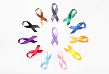 Fototapeta premium Different colorful awareness ribbons on white background. World Cancer Day