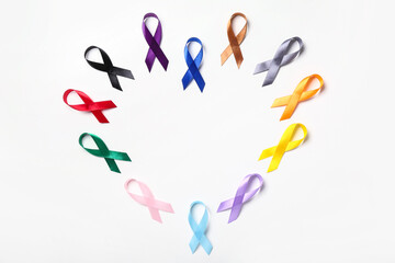 Heart shaped frame made of colorful awareness ribbons on white background. World Cancer Day concept