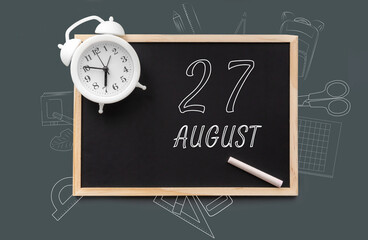 august 27. 27th day of month, calendar date. Blackboard with piece of chalk and white alarm clock on green background. Concept of day of year, time planner, summer month