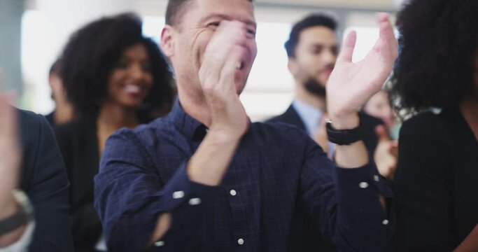 Excited diverse employees clapping hands, applauding and cheering, celebrating business achievement, sharing success, congratulating a colleague on promotion in a modern office