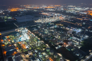 Aerial view of petrochemical oil refinery and sea in industrial engineering concept in Bangna district at night, Bangkok City, Thailand. Oil and gas tanks pipelines in industry