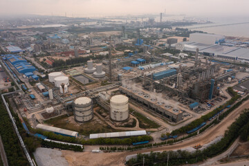 Fototapeta premium Aerial view of petrochemical oil refinery and sea in industrial engineering concept in Bangna district at night, Bangkok City, Thailand. Oil and gas tanks pipelines in industry