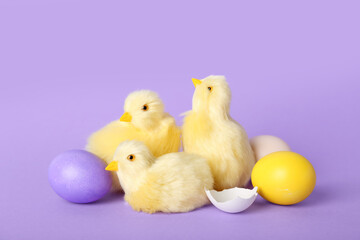 Cute chickens and Easter eggs on lilac background