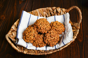 Homemade oatmeal cookies on wooden board on old table background. Healthy Food Snack Concept. Copy space