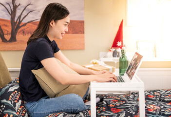 The  businesswoman sit at workplace desk looks at pc screen during group videocall with different age and ethnicity colleagues using application and webcam,