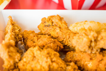 Hot crispy fried chicken on white plate.