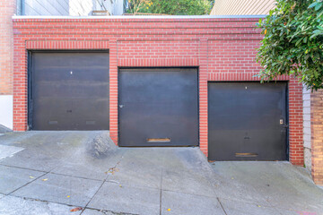 Garage exterior with three black canopy doors at San Francisco, California