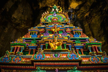 Gombak, Malaysia - January 4, 2020: Beautiful and colorful architectural building inside the Batu Caves. Statue of Hindu God in Batu caves Indian Temple, Kuala Lumpur. Image contain bit out of focus.