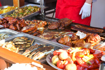Assorted grilled chicken and pork and various grilled vegetables for summer family dinner.
