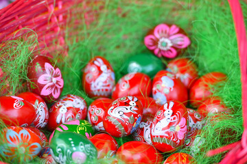 Eggs painted on the occasion of the Easter holidays placed in a basket with grass.