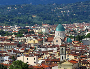 Fototapeta na wymiar Dome of the synogogue of the city of Florence in Italy in the Tuscany Region and the roofs of the houses