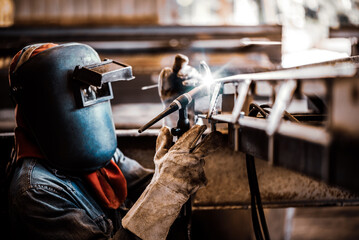 Industrial welder welding fabricated stainless construction work in factory, Welding process by Gas Tungsten Arc Welding - GTAW. - obrazy, fototapety, plakaty
