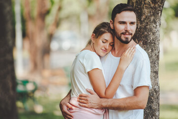 Young couple lover dating and hugging in love at spring garden park, copy space, Romantic love concept.