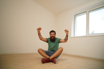 Excited man moving to new home. Moving to a empty apartment.