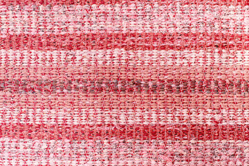 Traditional woven rug shades of red motley. Carpet made from recycled fabric. rustic mat