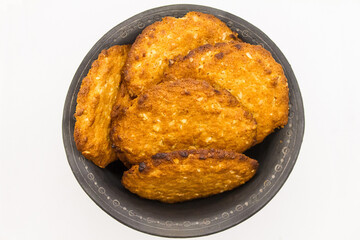 black ceramic bowl with biscuits on a white background