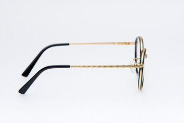 Round shape sunglasses gold and black frames on white background