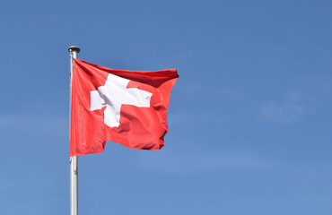 Naklejka na ściany i meble Blowing flag of switzerland red with white cross