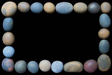 A frame of coloured pebbles on a black background