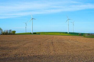 Wind energy in Germany behind farmland, environmental discussion, substainable renewable electricity