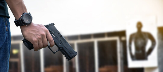 9mm automatic pistol holding in right hand of shooter, concept for security, robbery, gangster,...