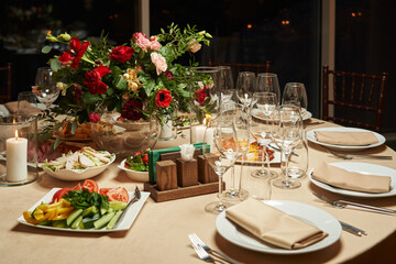 transparent wine glasses on a beautiful festive table decorated with flowers