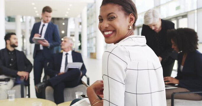 Positivity paired with team ethic is the recipe for success. 4k video footage of a happy young businesswoman sitting in on a meeting with her colleagues in a modern office.