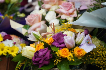 Bright bouquets of flowers with decorative paper on sale.
