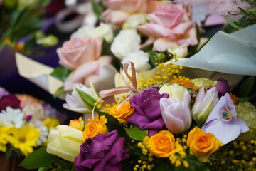 Bright bouquets of flowers with decorative paper on sale.