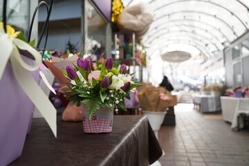 Bright bouquets of flowers with decorative paper on sale.