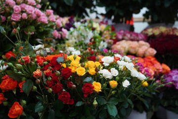 Bright bouquets of flowers with decorative paper on sale.