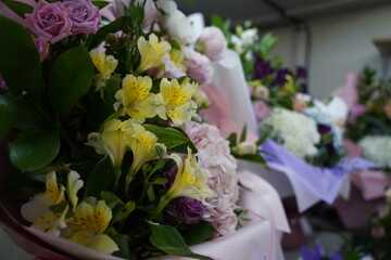 Bright bouquets of flowers with decorative paper on sale.
