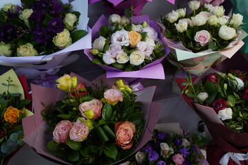 Bright bouquets of flowers with decorative paper on sale.