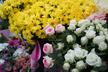 Bright bouquets of flowers with decorative paper on sale.