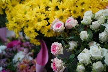 Bright bouquets of flowers with decorative paper on sale.