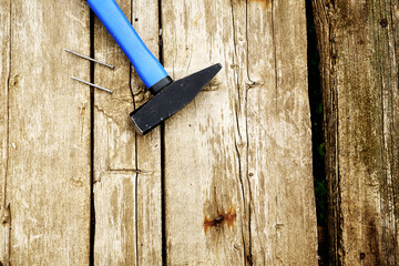 iron hammer and nails on old wooden boards with copyscape
